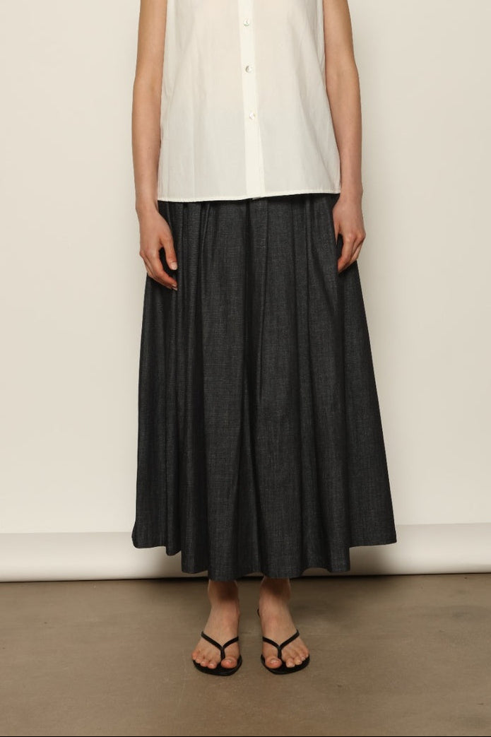Model wearing the Seoul Ink Denim Skirt by House of Woven Stories, featuring deep indigo denim, a structured silhouette, and refined tailoring for a timeless and elegant look.