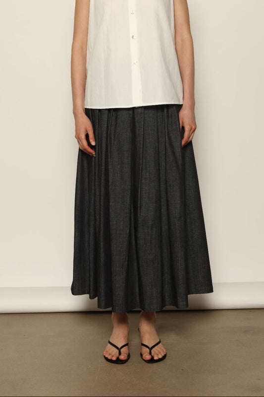 Model wearing the Seoul Ink Denim Skirt by House of Woven Stories, featuring deep indigo denim, a structured silhouette, and refined tailoring for a timeless and elegant look.
