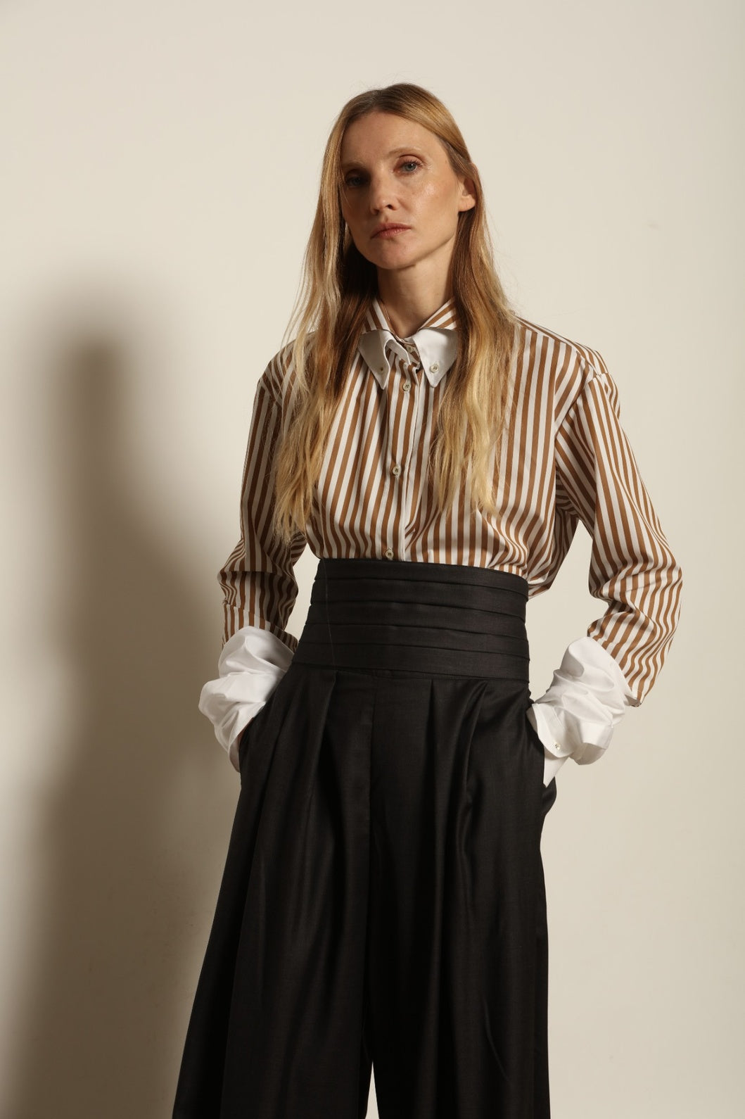 Model is wearing the Sergey Anthracite Cummerbund by House of Woven Stories, a sculptural pleated waist belt in deep anthracite designed to define the silhouette with refined elegance.