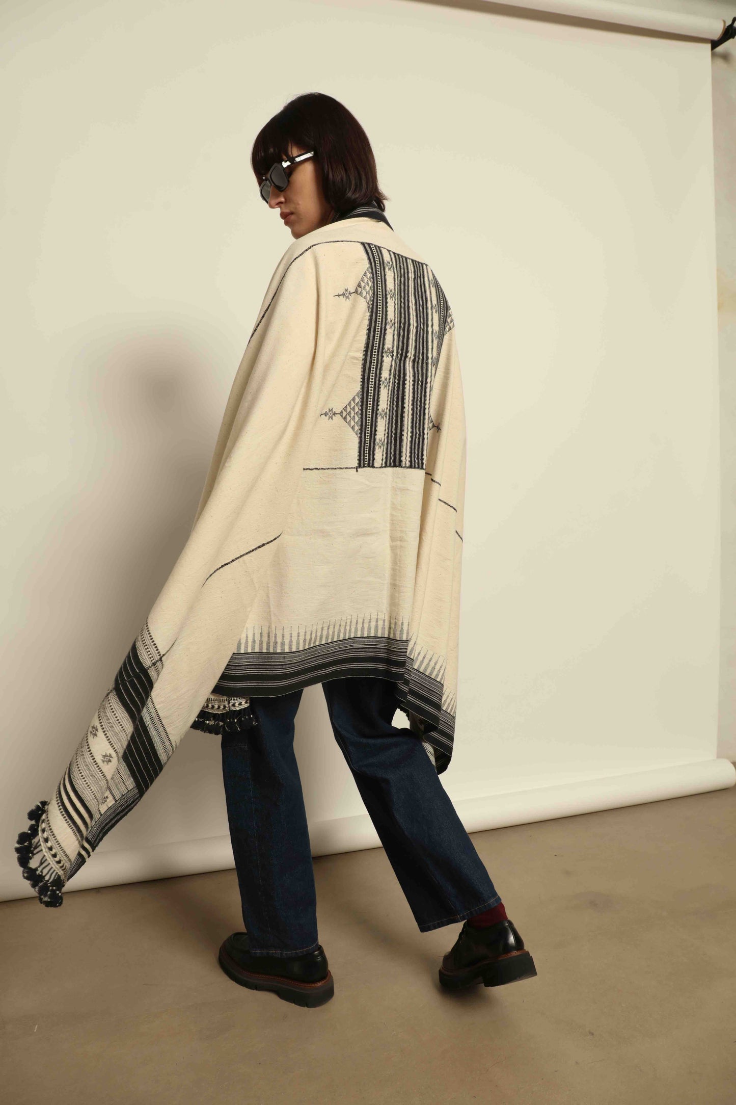 Handwoven Kala cotton throw Ananta by House of Woven Stories, crafted with handspun yarn and embroidered panels by master weaver Shamji Vankar Vishram Valji in Bhujodi, India.
