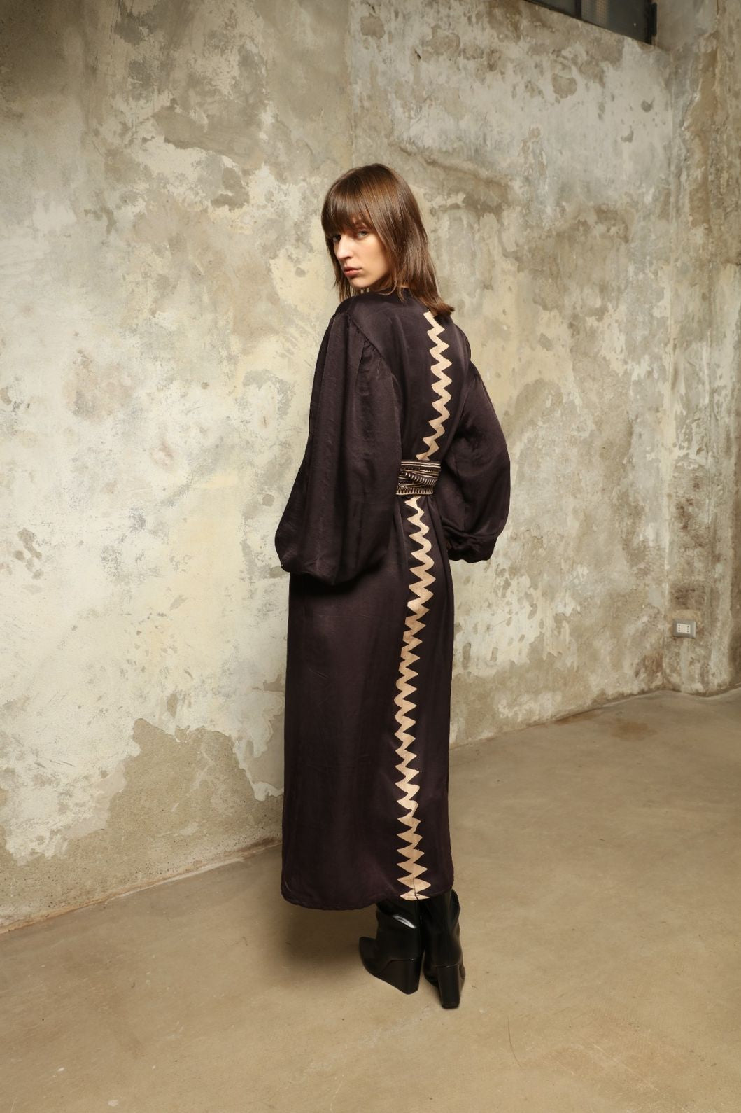 Model is wearing the Ibiza Silk Dress with Belt by House of Woven Stories, made from Seta Mulberry silk with hand-printed Ajrakh patterns, styled with two silk belts for a versatile silhouette.