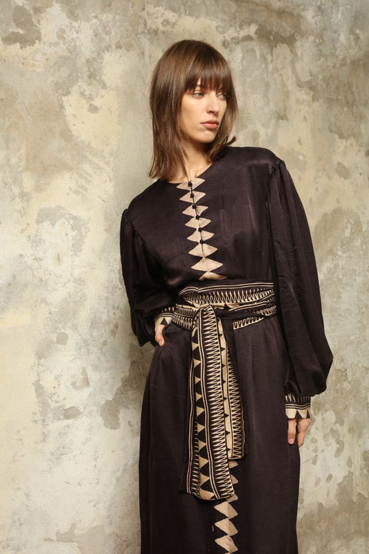 Model is wearing the Ibiza Silk Dress with Belt by House of Woven Stories, made from Seta Mulberry silk with hand-printed Ajrakh patterns, styled with two silk belts for a versatile silhouette.