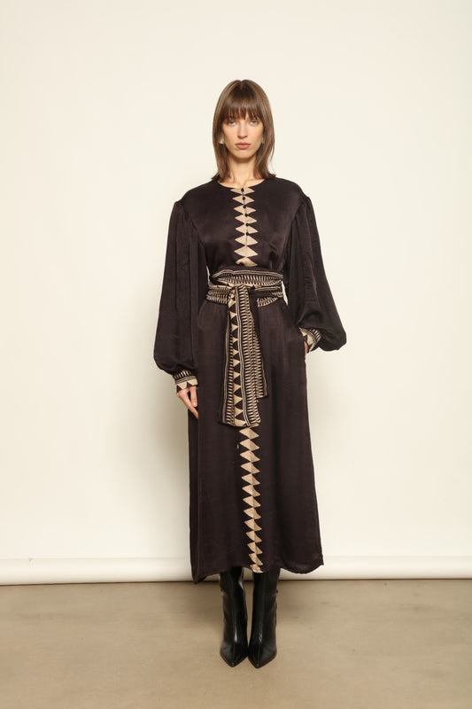 Model is wearing the Ibiza Silk Dress with Belt by House of Woven Stories, made from Seta Mulberry silk with hand-printed Ajrakh patterns, styled with two silk belts for a versatile silhouette.