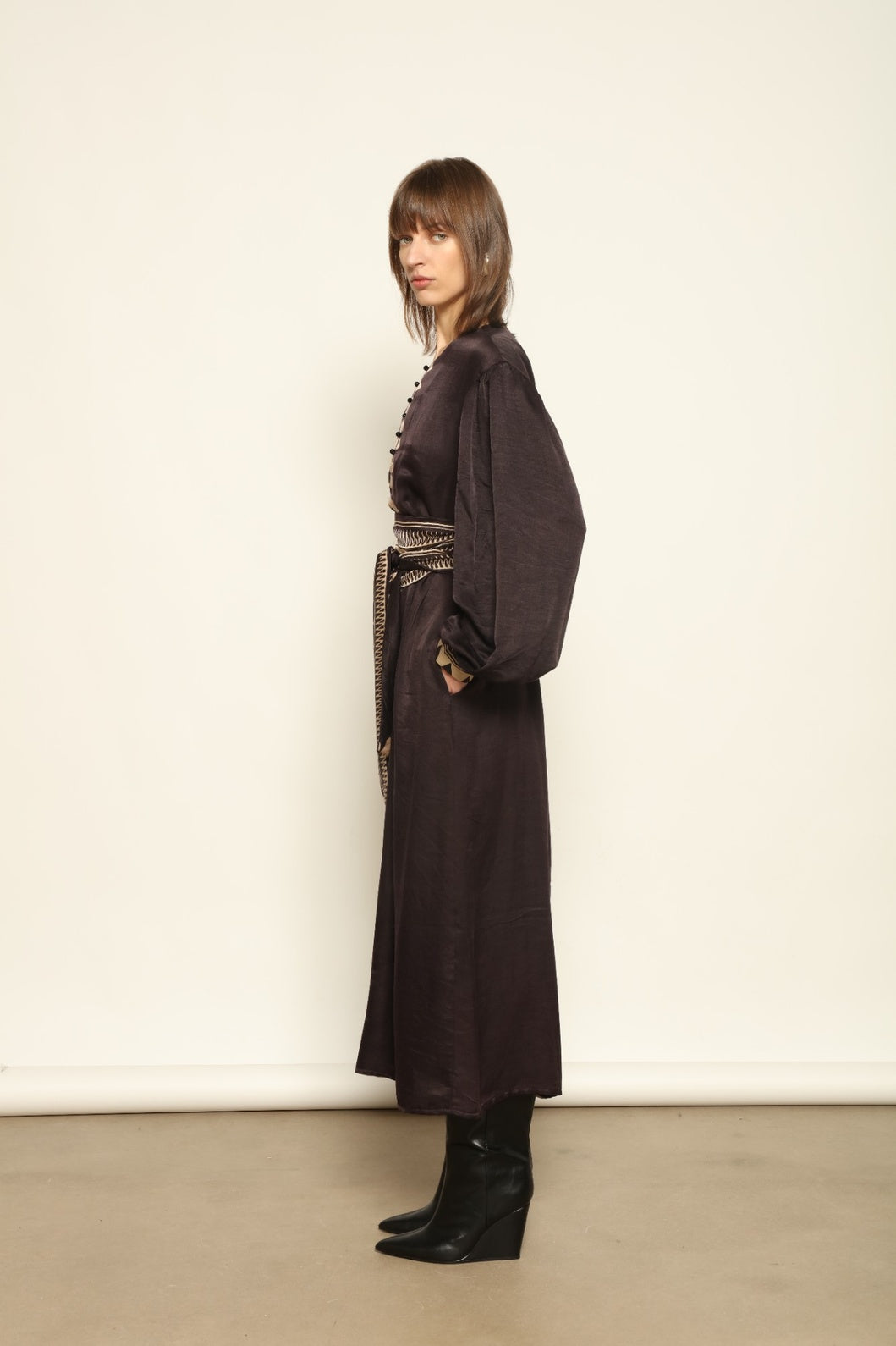 Model is wearing the Ibiza Silk Dress with Belt by House of Woven Stories, made from Seta Mulberry silk with hand-printed Ajrakh patterns, styled with two silk belts for a versatile silhouette.