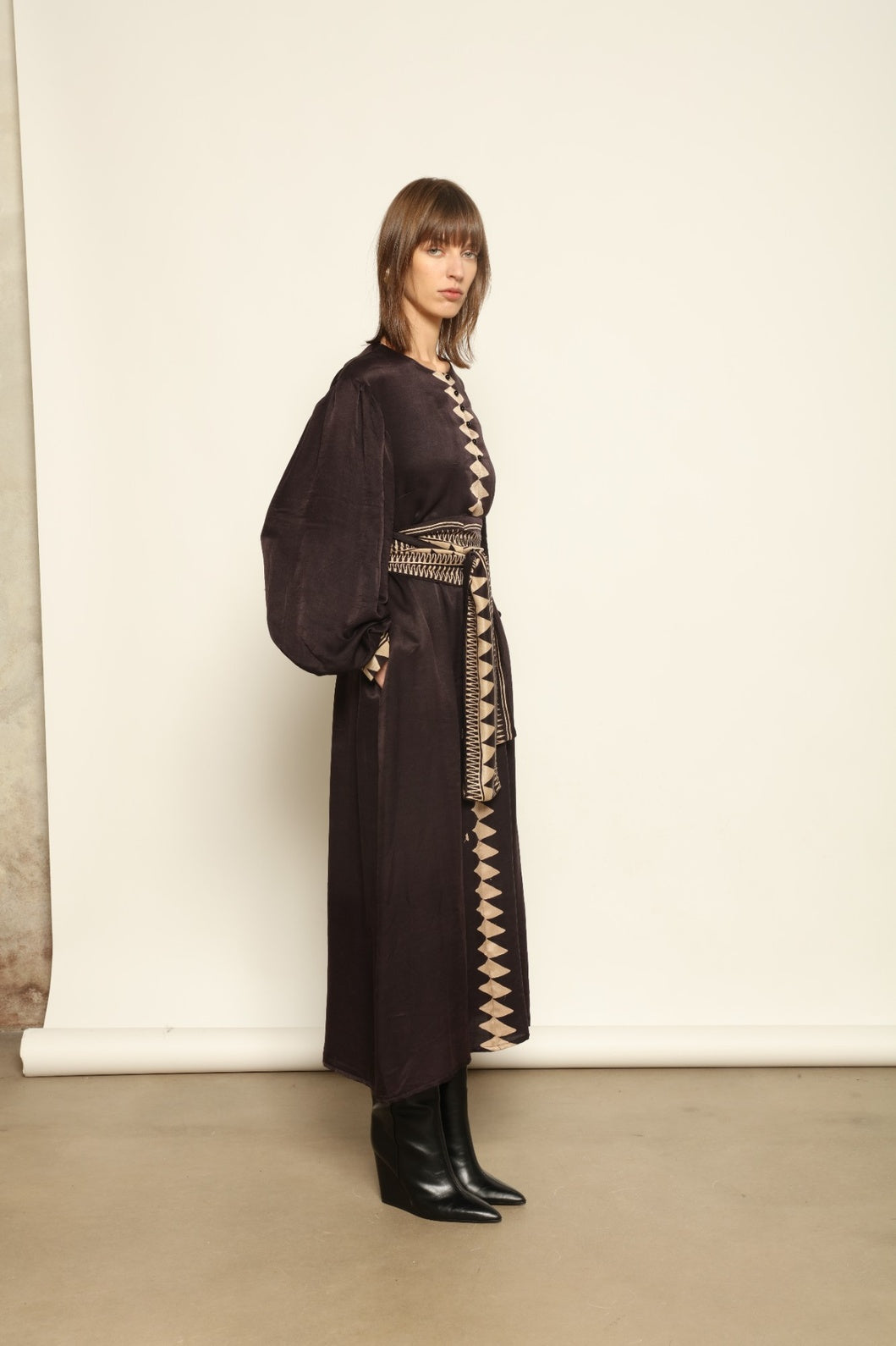 Model is wearing the Ibiza Silk Dress with Belt by House of Woven Stories, made from Seta Mulberry silk with hand-printed Ajrakh patterns, styled with two silk belts for a versatile silhouette.