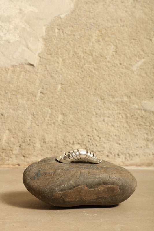 Idra Silver Earcuff by SO-LE STUDIO, part of the curated selection at House of Woven Stories, handcrafted in Italy from upcycled Ferragamo leather with a mirrored silver finish, sculptural curved form, and minimalist sustainable design.
