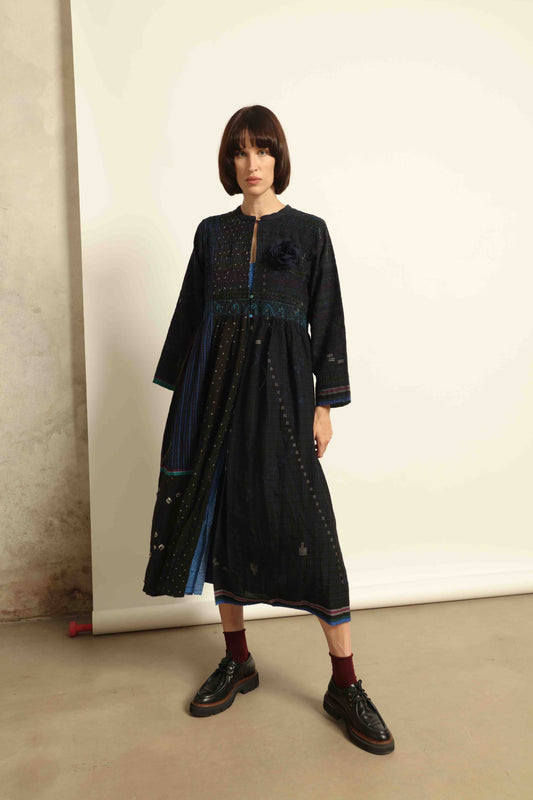 Model is wearing the Folklore 20 dress by Injiri, handmade from silk and wool using traditional Indian handloom techniques, featuring a round neckline, long sleeves, side pockets, and a flattering cut below the bust, curated by House of Woven Stories.