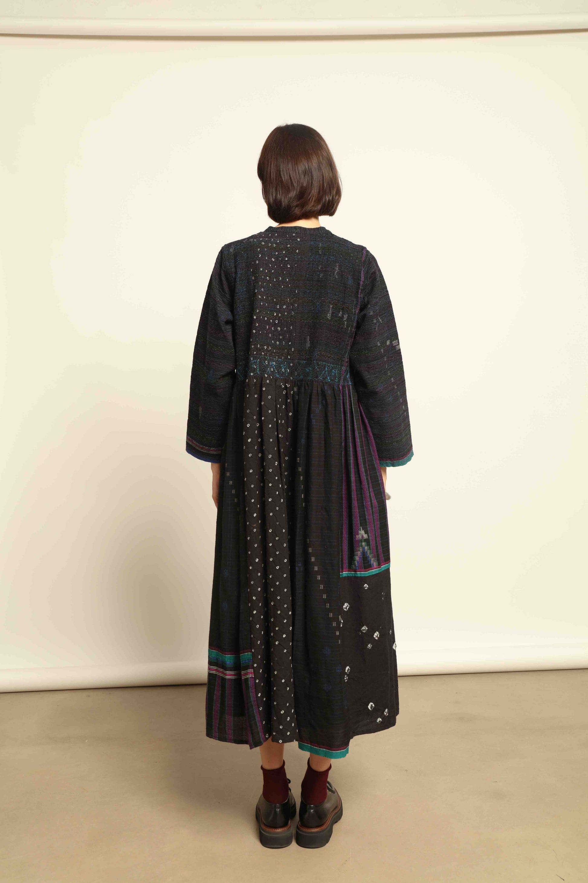 Model is wearing the Folklore 20 dress by Injiri, handmade from silk and wool using traditional Indian handloom techniques, featuring a round neckline, long sleeves, side pockets, and a flattering cut below the bust, curated by House of Woven Stories.
