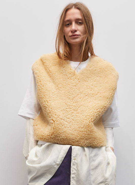 Model wearing the Jejia Cream Mutton V-Neck by Maison Jejia, featuring soft faux mutton fabric, creamy tone, cropped silhouette, clean V-neckline, and cozy layering design, part of the House of Woven Stories Selection