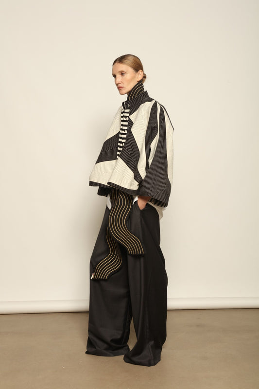 Model is wearing the Tri Crop Moma in black by Ka-Sha, a sculptural heavyweight organic cotton cropped top with geometric panels, curated in the House of Woven Stories selection.