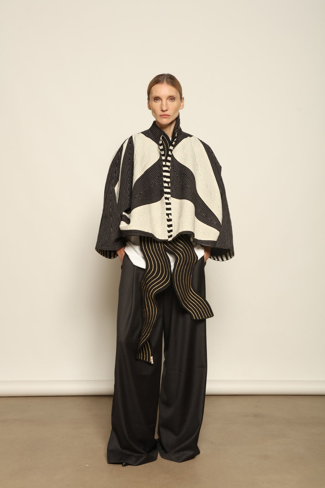 Model is wearing the Tri Crop Moma in black by Ka-Sha, a sculptural heavyweight organic cotton cropped top with geometric panels, curated in the House of Woven Stories selection.