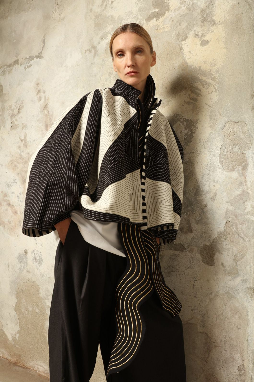 Model is wearing the Tri Crop Moma in black by Ka-Sha, a sculptural heavyweight organic cotton cropped top with geometric panels, curated in the House of Woven Stories selection.