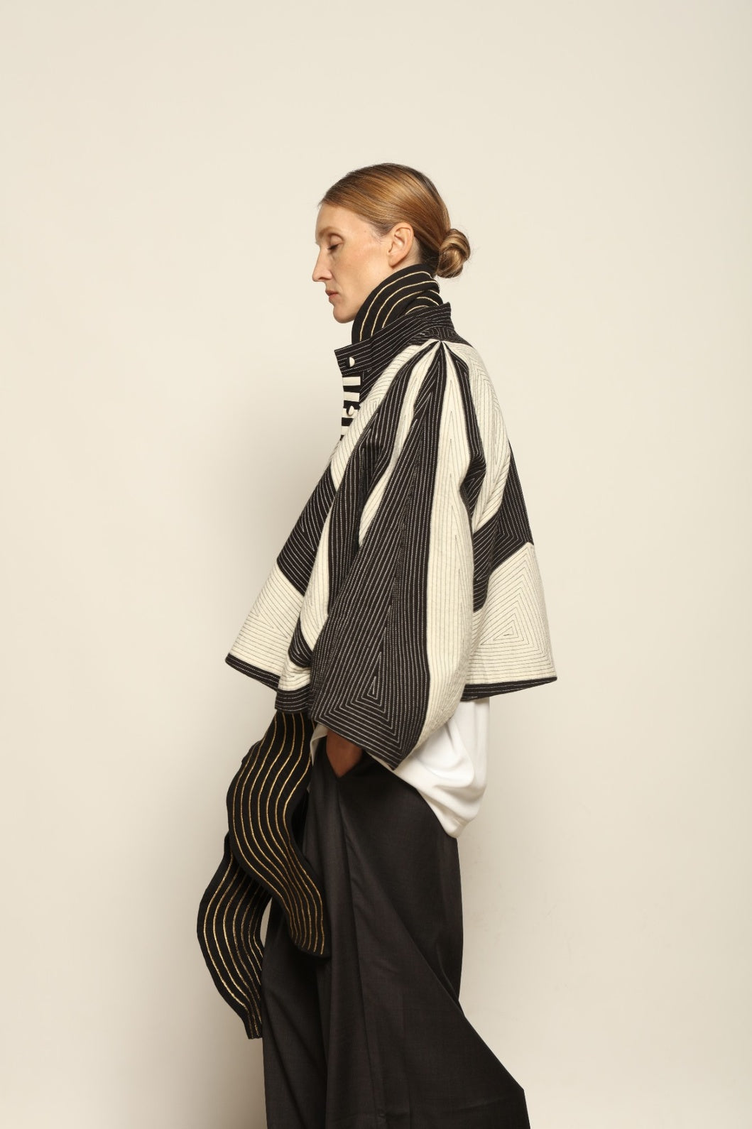 Model is wearing the Tri Crop Moma in black by Ka-Sha, a sculptural heavyweight organic cotton cropped top with geometric panels, curated in the House of Woven Stories selection.