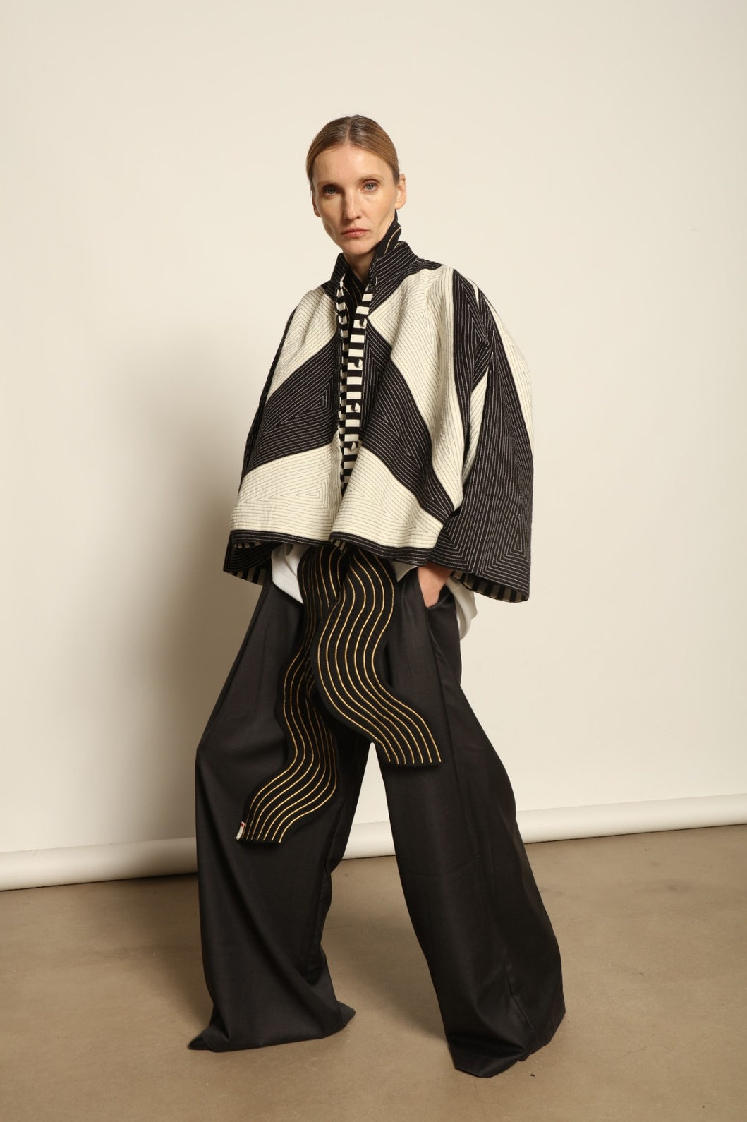 Model is wearing the Tri Crop Moma in black by Ka-Sha, a sculptural heavyweight organic cotton cropped top with geometric panels, curated in the House of Woven Stories selection.