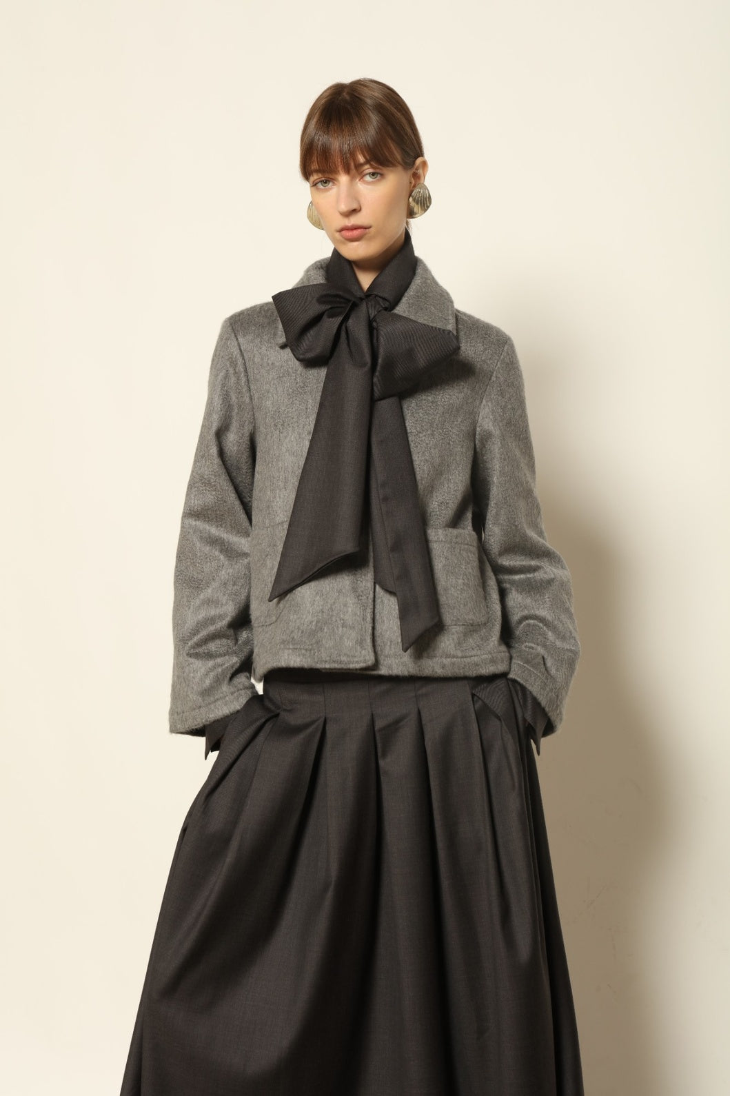 Model is wearing the Katharina Grey Pure Cashmere Wool Jacket by House of Woven Stories, crafted in Italy from upcycled cashmere wool with antique silk sari lining and vintage buttons.