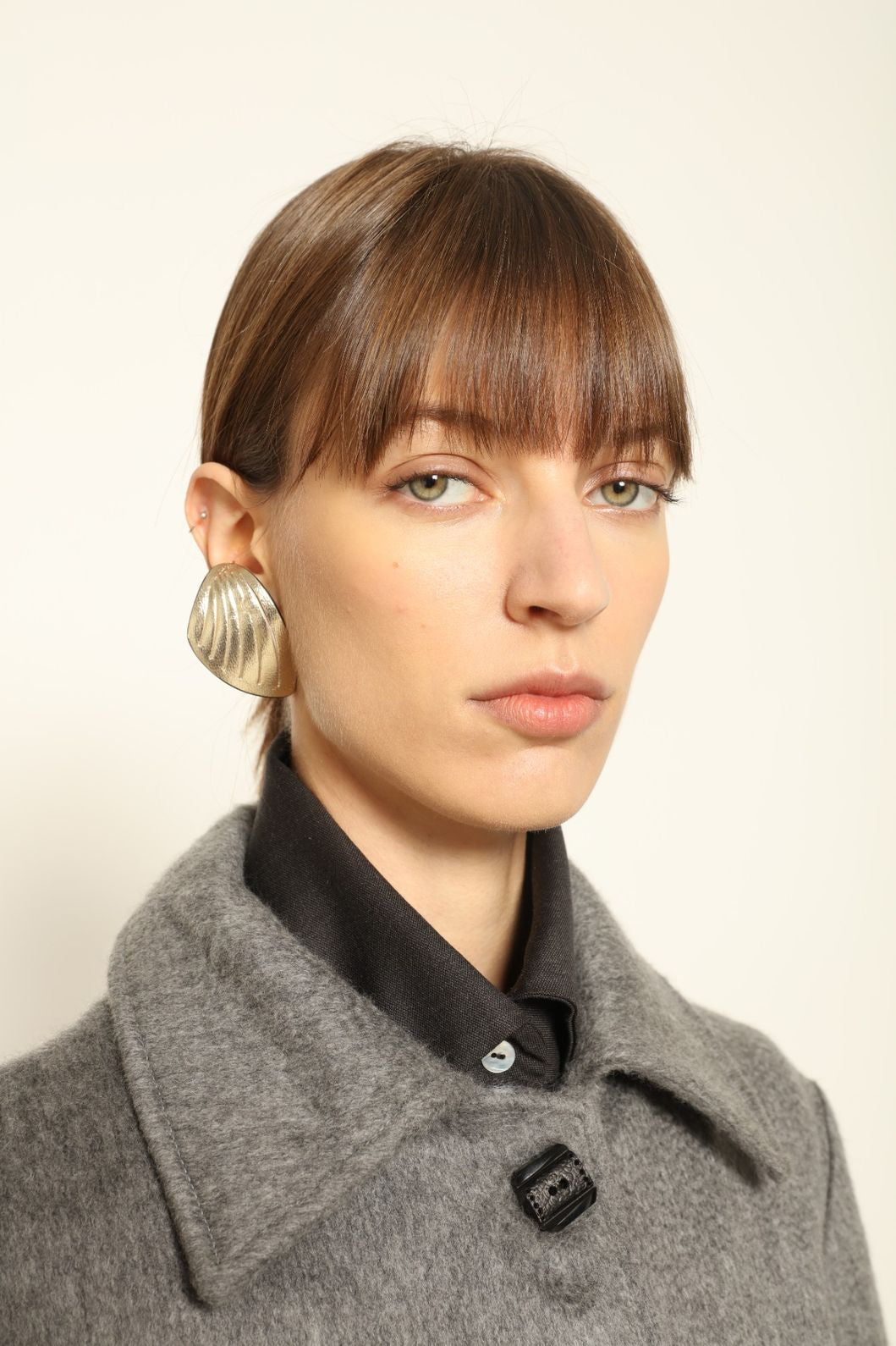 Model is wearing the Katharina Grey Pure Cashmere Wool Jacket by House of Woven Stories, crafted in Italy from upcycled cashmere wool with antique silk sari lining and vintage buttons.