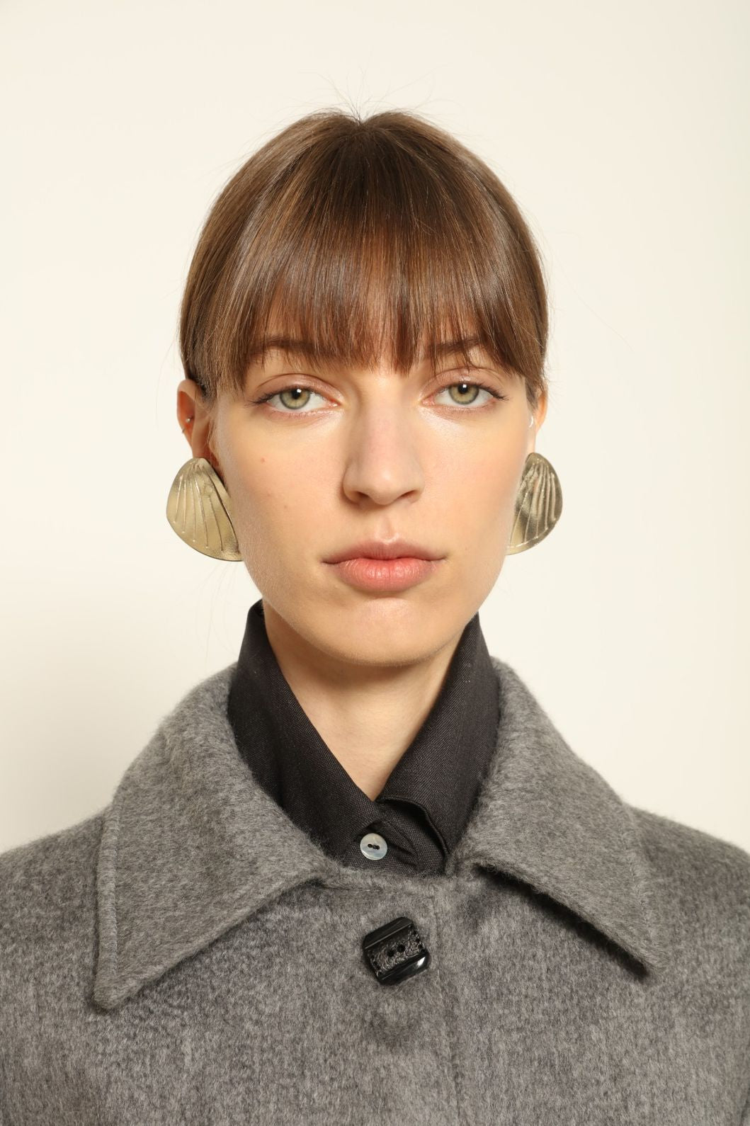 Model is wearing the Katharina Grey Pure Cashmere Wool Jacket by House of Woven Stories, crafted in Italy from upcycled cashmere wool with antique silk sari lining and vintage buttons.