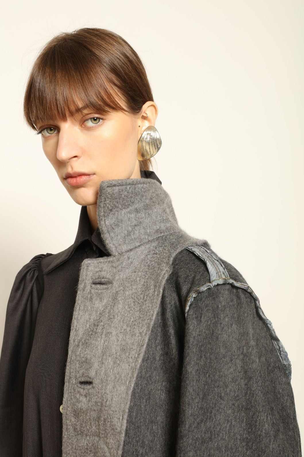 Model is wearing the Katharina Grey Pure Cashmere Wool Jacket by House of Woven Stories, crafted in Italy from upcycled cashmere wool with antique silk sari lining and vintage buttons.