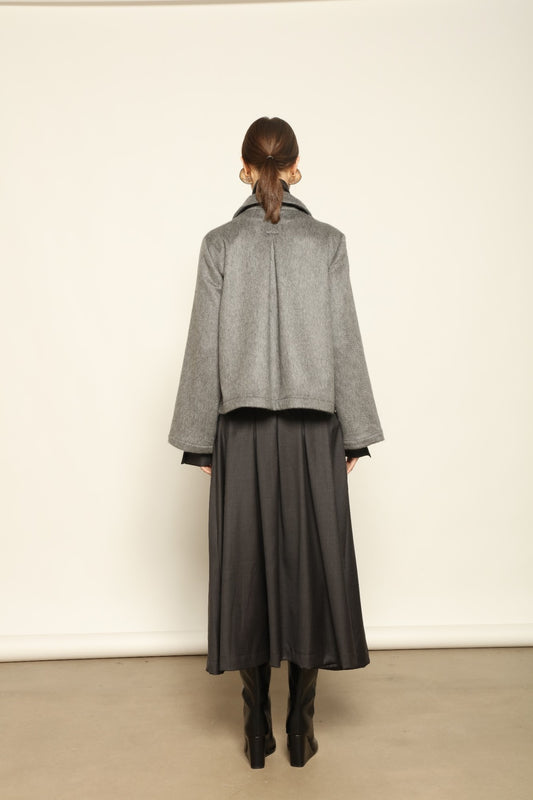 Model is wearing the Katharina Grey Pure Cashmere Wool Jacket by House of Woven Stories, crafted in Italy from upcycled cashmere wool with antique silk sari lining and vintage buttons.