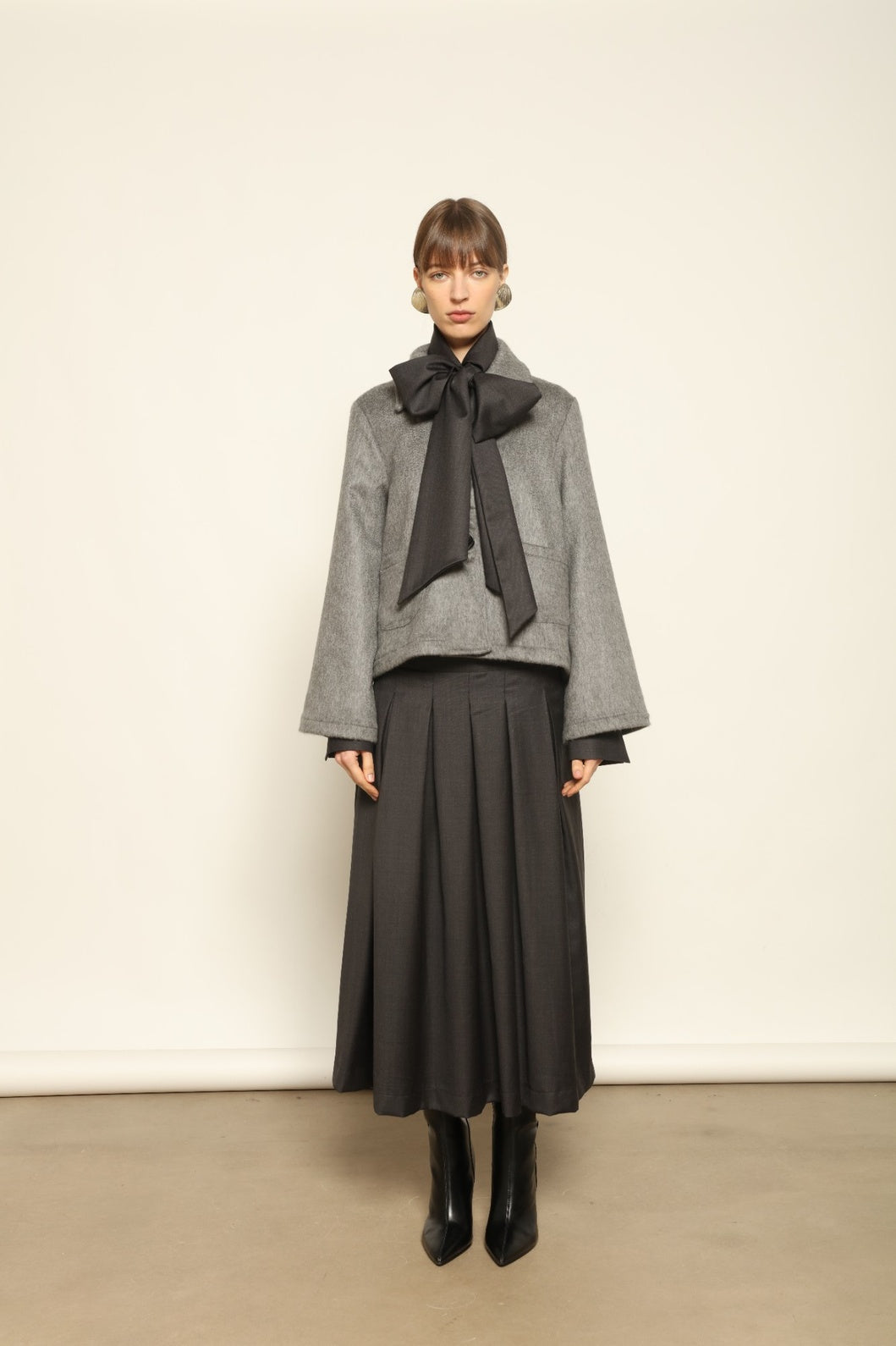 Model is wearing the Katharina Grey Pure Cashmere Wool Jacket by House of Woven Stories, crafted in Italy from upcycled cashmere wool with antique silk sari lining and vintage buttons.