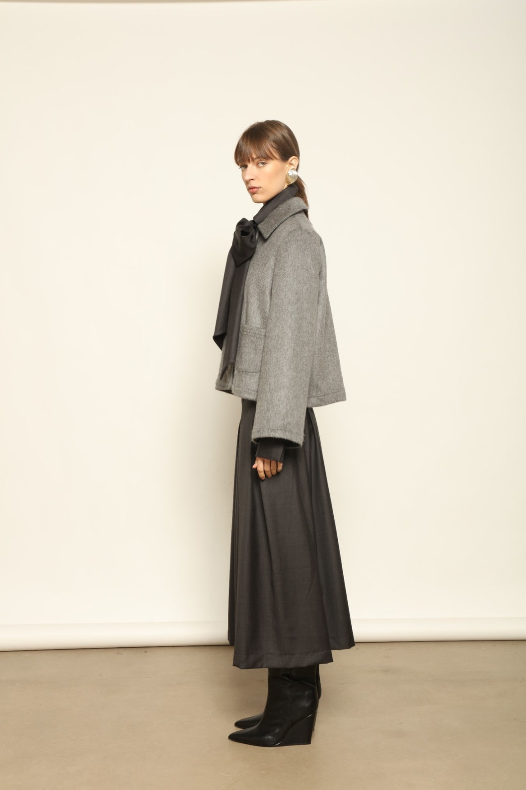 Model is wearing the Katharina Grey Pure Cashmere Wool Jacket by House of Woven Stories, crafted in Italy from upcycled cashmere wool with antique silk sari lining and vintage buttons.