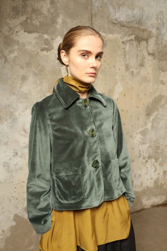 Model wearing Katharina Jacket in Velvet Green Cotton by House of Woven Stories, part of the curated selection, handcrafted in Italy from fine cotton velvet with hand-dyed shibori lining, expressing timeless elegance and artisanal craftsmanship.