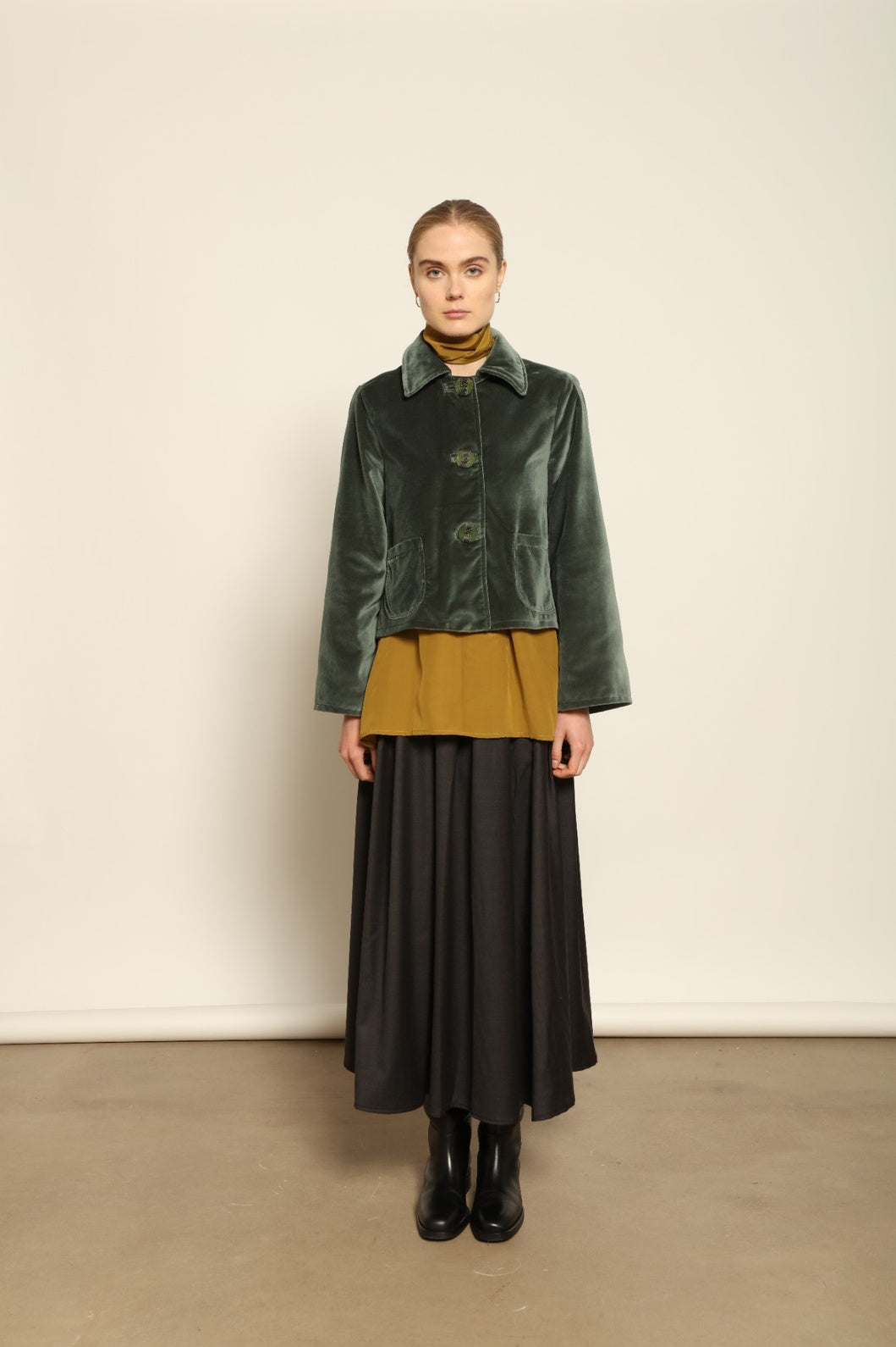 Model wearing Katharina Jacket in Velvet Green Cotton by House of Woven Stories, part of the curated selection, handcrafted in Italy from fine cotton velvet with hand-dyed shibori lining, expressing timeless elegance and artisanal craftsmanship.