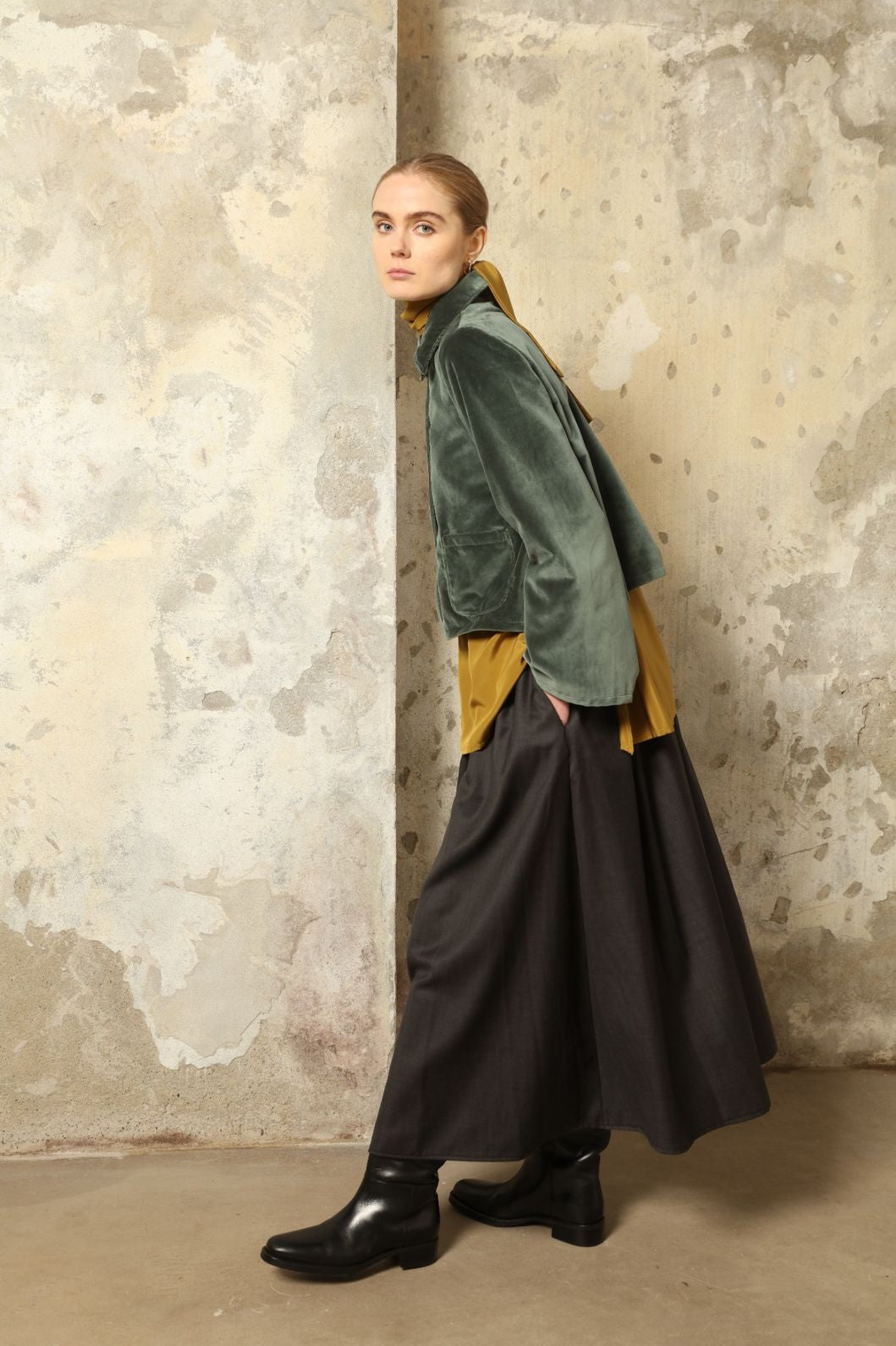 Model wearing Katharina Jacket in Velvet Green Cotton by House of Woven Stories, part of the curated selection, handcrafted in Italy from fine cotton velvet with hand-dyed shibori lining, expressing timeless elegance and artisanal craftsmanship.