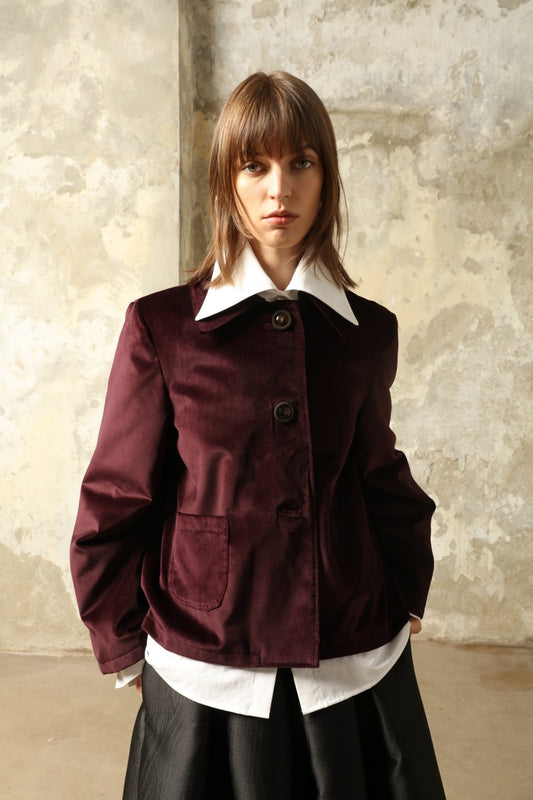 Model is wearing the Katharina Velvet Burgundy Cotton Jacket by House of Woven Stories, crafted from cotton velvet with an A-shape silhouette and hand-printed silk lining.
