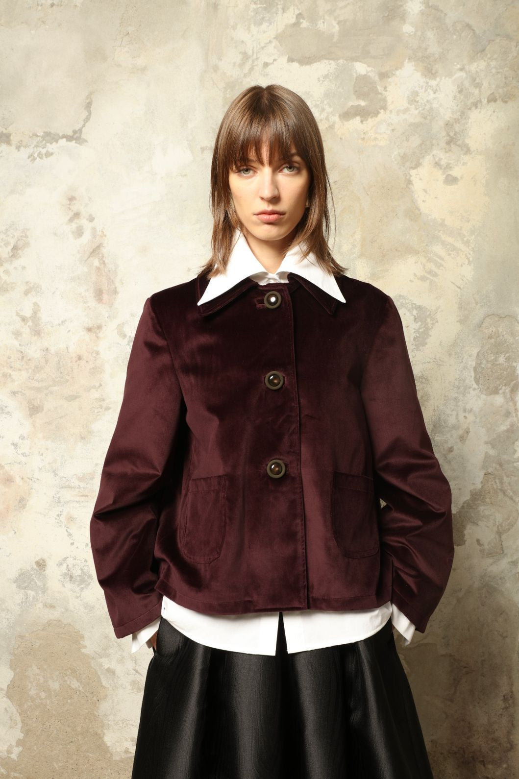 Model is wearing the Katharina Velvet Burgundy Cotton Jacket by House of Woven Stories, crafted from cotton velvet with an A-shape silhouette and hand-printed silk lining.