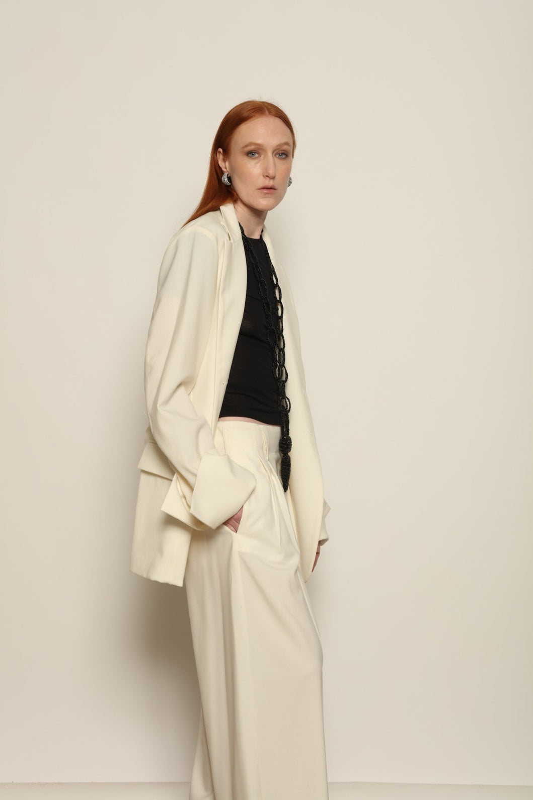 Model is wearing the Katherine white cotton pant by Maison Jejia from the House of Woven Stories selection, featuring a fluid wide-leg silhouette crafted in Italy with refined tailoring and a clean, timeless design.