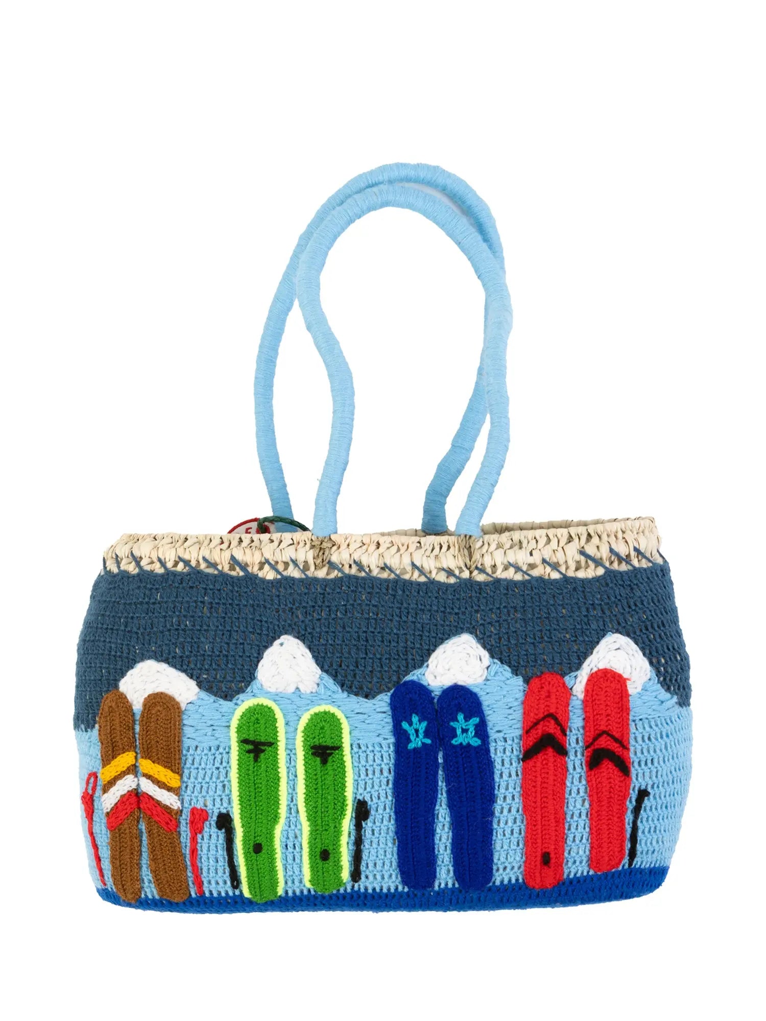 Undercover basket bag by Kilometre Paris inspired by winter exploration in Vail, Colorado, featuring embroidered mountain landscapes in blue and white on handwoven straw