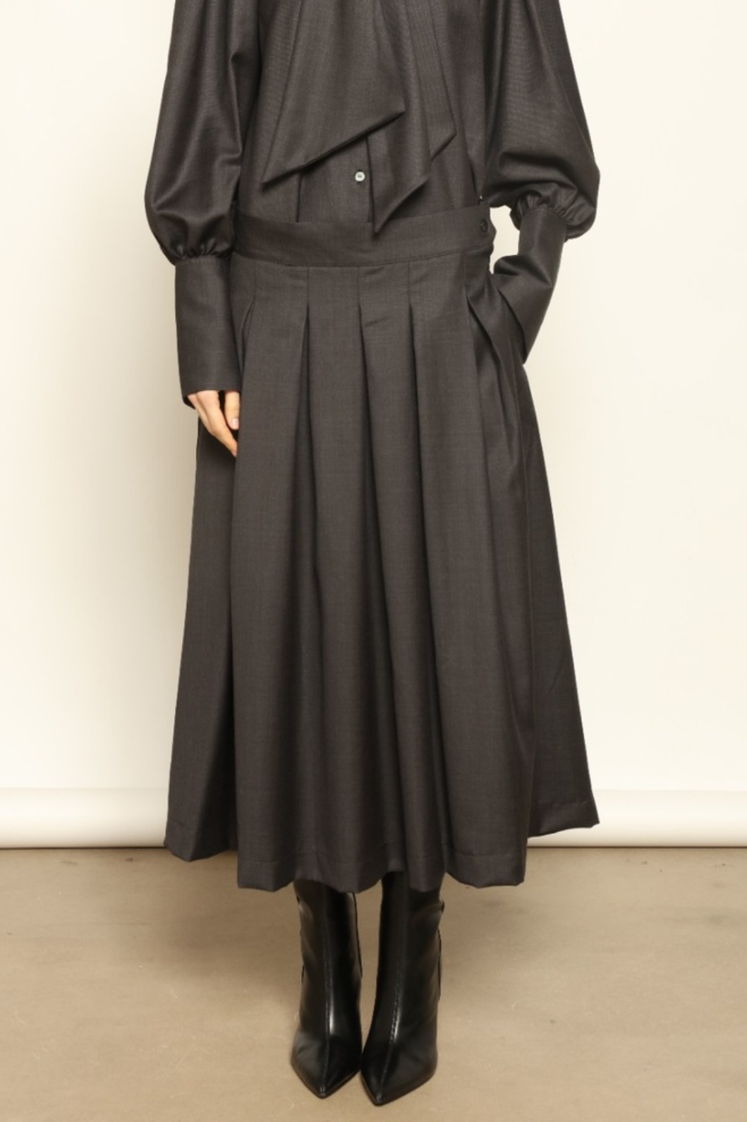 Larissa Super 100% Merino Wool Skirt by House of Woven Stories – midi-length pleated skirt in soft, luxurious merino wool, tailored in Piemonte, Italy for timeless elegance and comfort.