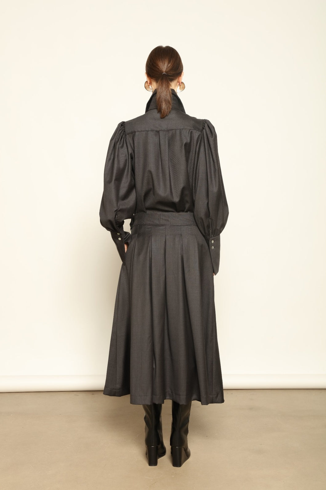 Larissa Super 100% Merino Wool Skirt by House of Woven Stories – midi-length pleated skirt in soft, luxurious merino wool, tailored in Piemonte, Italy for timeless elegance and comfort.