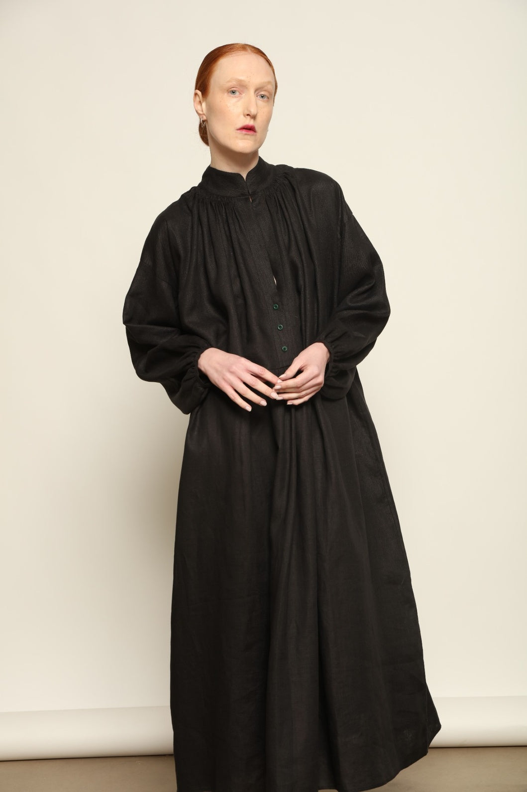 Model is wearing the Les Vacances d’Irina Black Sea Linen Dress, handcrafted from 100% linen with billowing sleeves and a gathered neckline, from the House of Nomad Stories selection.