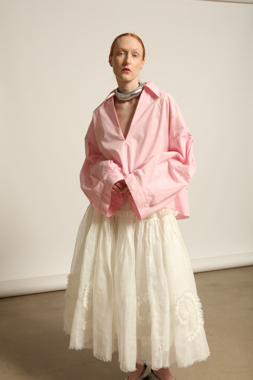 Model is wearing the Les Vacances d’Irina Shell White Skirt, handcrafted from linen with voluminous silhouette and hand-applied ruffles, from the House of Nomad Stories selection.