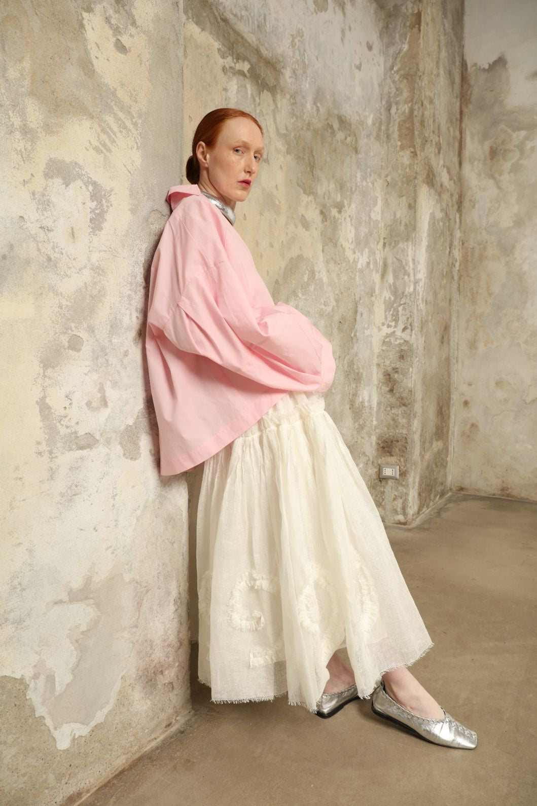 Model is wearing the Les Vacances d’Irina Shell White Skirt, handcrafted from linen with voluminous silhouette and hand-applied ruffles, from the House of Nomad Stories selection.
