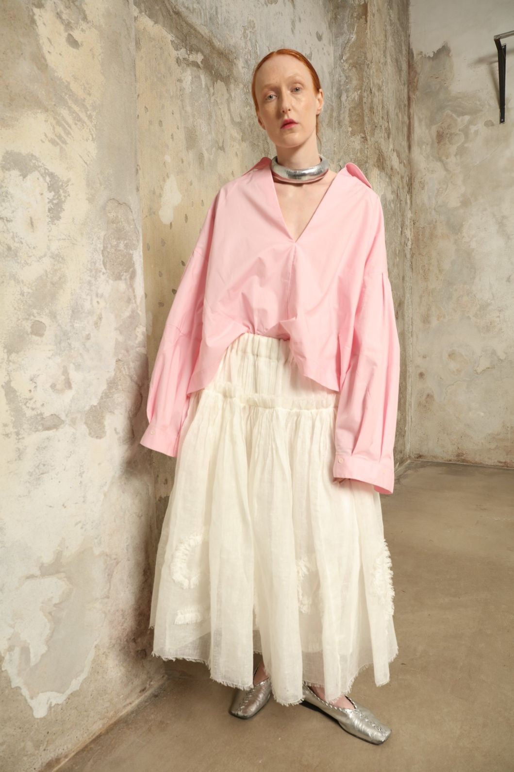 Model is wearing the Les Vacances d’Irina Shell White Skirt, handcrafted from linen with voluminous silhouette and hand-applied ruffles, from the House of Nomad Stories selection.