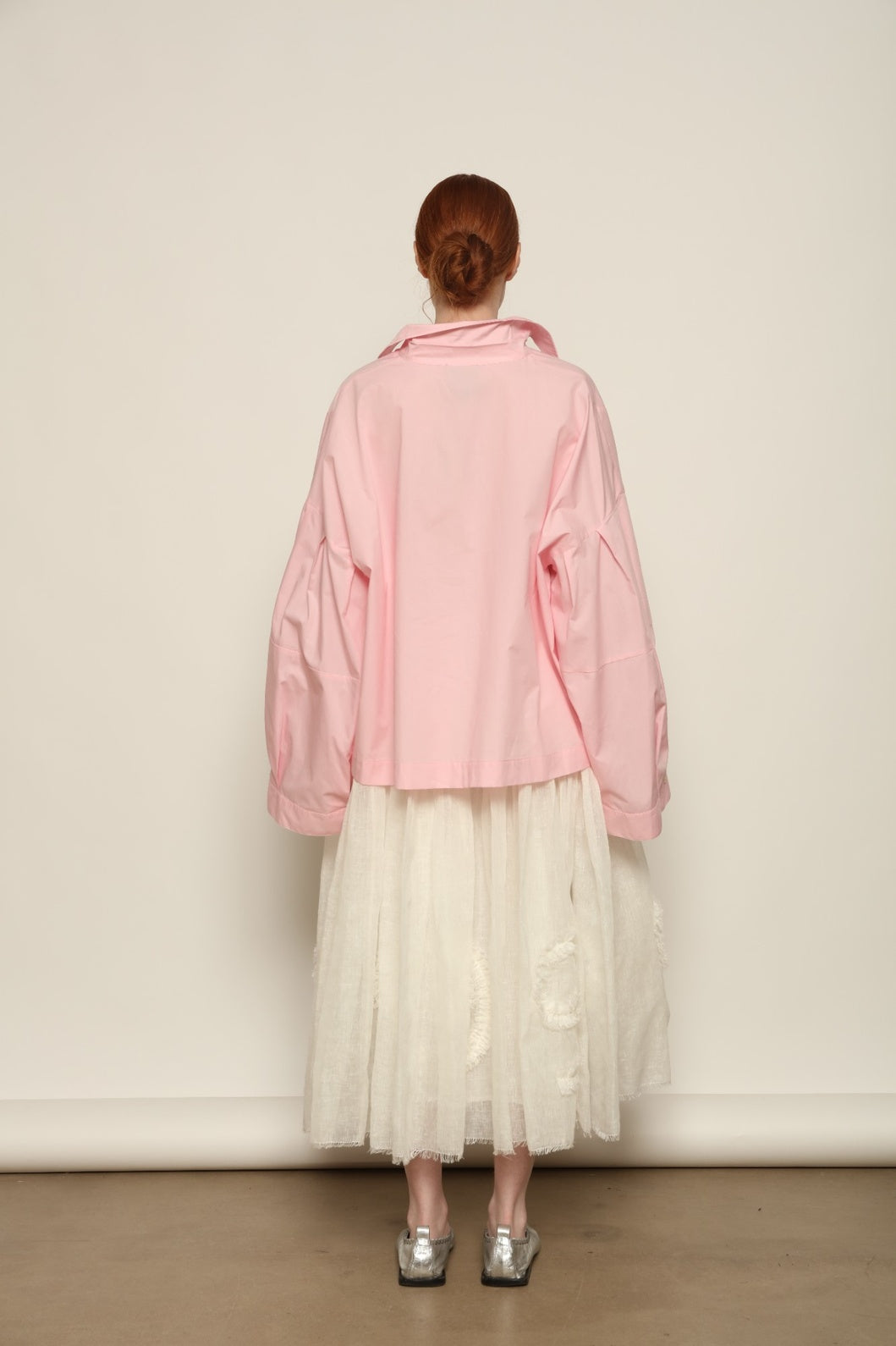 Model is wearing the Les Vacances d’Irina Shell White Skirt, handcrafted from linen with voluminous silhouette and hand-applied ruffles, from the House of Nomad Stories selection.