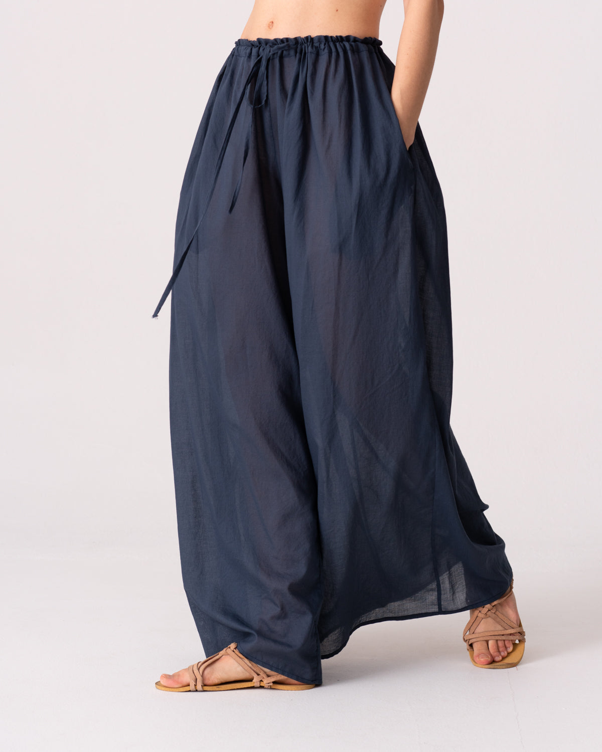 Model is wearing the Liquid Navy Cotton Pantaloons by Les Vacances d’Irina, wide-leg handmade cotton voile pants with drawstring waist and side pockets, available at House of Woven Stories.