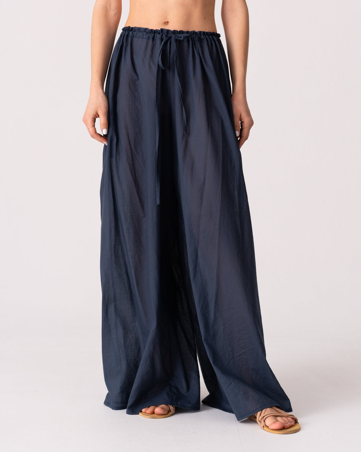 Model is wearing the Liquid Navy Cotton Pantaloons by Les Vacances d’Irina, wide-leg handmade cotton voile pants with drawstring waist and side pockets, available at House of Woven Stories.