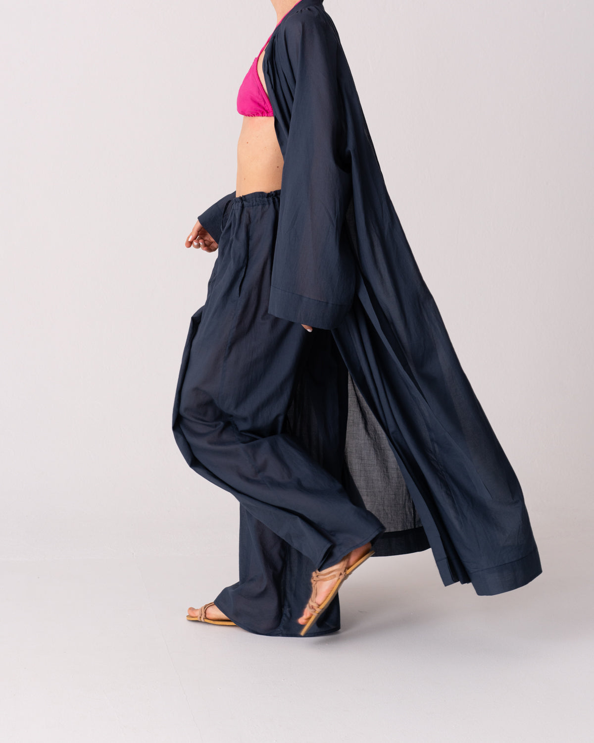 Model is wearing the Liquid Navy Cotton Pantaloons by Les Vacances d’Irina, wide-leg handmade cotton voile pants with drawstring waist and side pockets, available at House of Woven Stories.