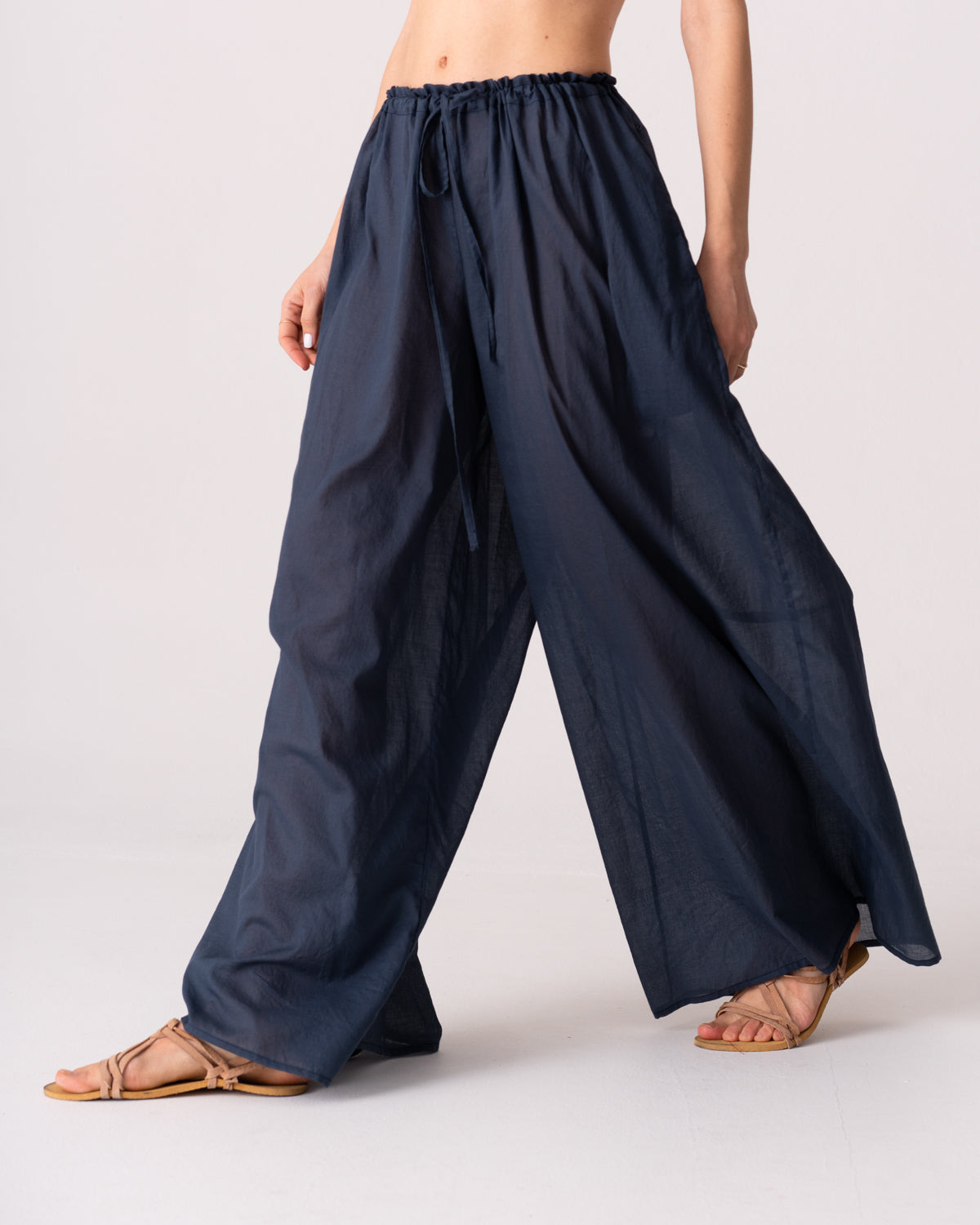 Model is wearing the Liquid Navy Cotton Pantaloons by Les Vacances d’Irina, wide-leg handmade cotton voile pants with drawstring waist and side pockets, available at House of Woven Stories.