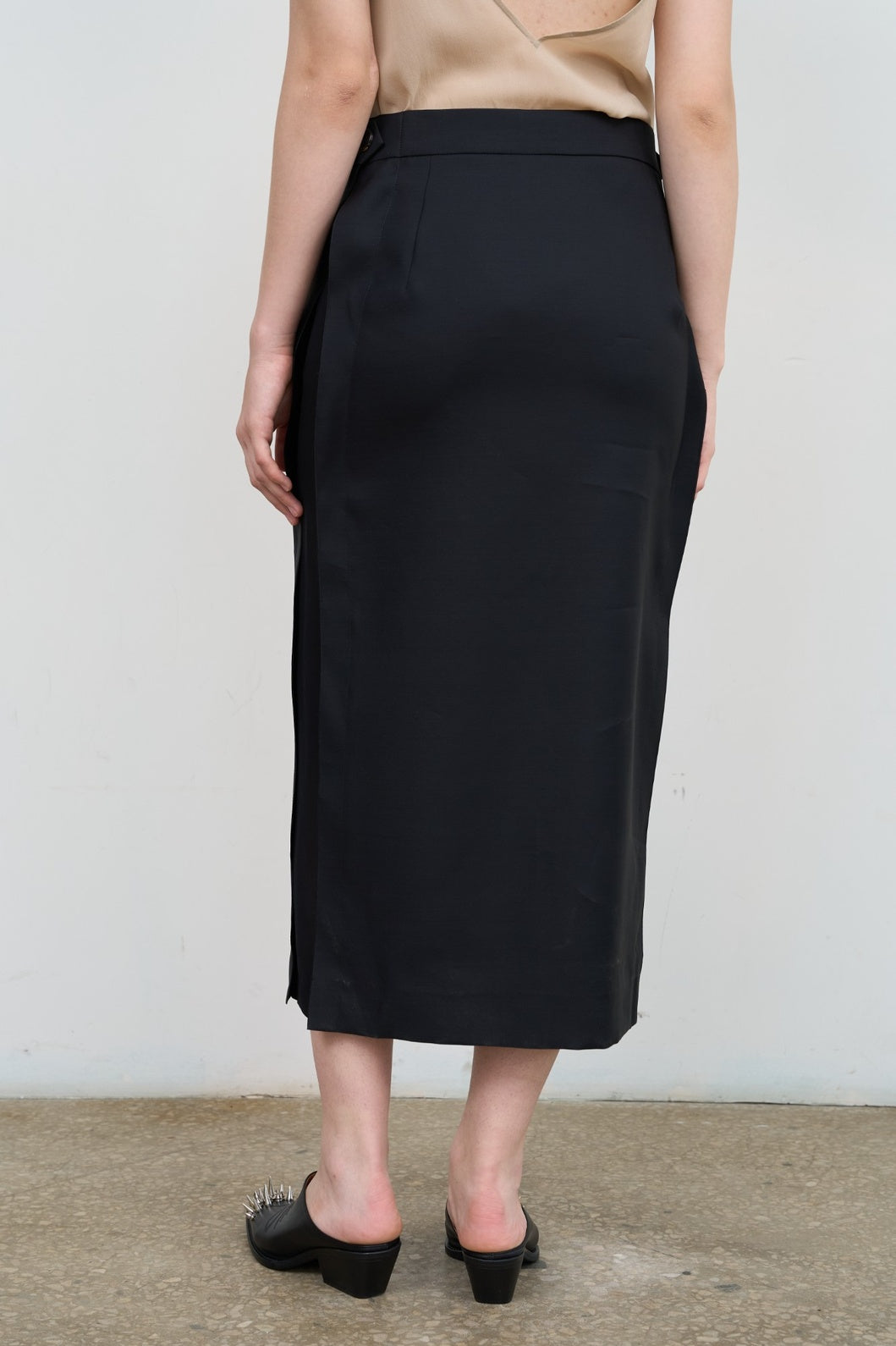 Model is wearing Litkovska black skirt with side stripes, tailored waist, and fluid drape. A modern, versatile, and artisanal piece that belongs to the curated selection of House of Nomad Stories.