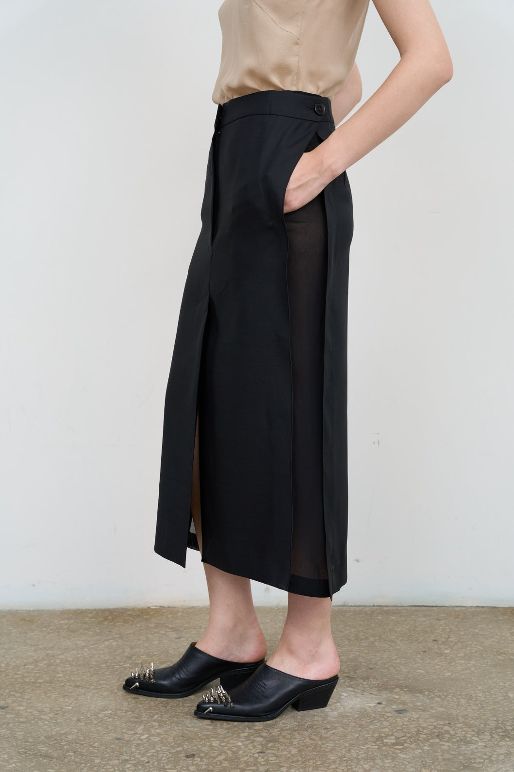 Model is wearing Litkovska black skirt with side stripes, tailored waist, and fluid drape. A modern, versatile, and artisanal piece that belongs to the curated selection of House of Nomad Stories.