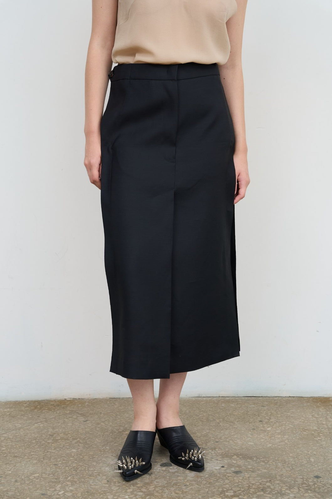 Model is wearing Litkovska black skirt with side stripes, tailored waist, and fluid drape. A modern, versatile, and artisanal piece that belongs to the curated selection of House of Nomad Stories.