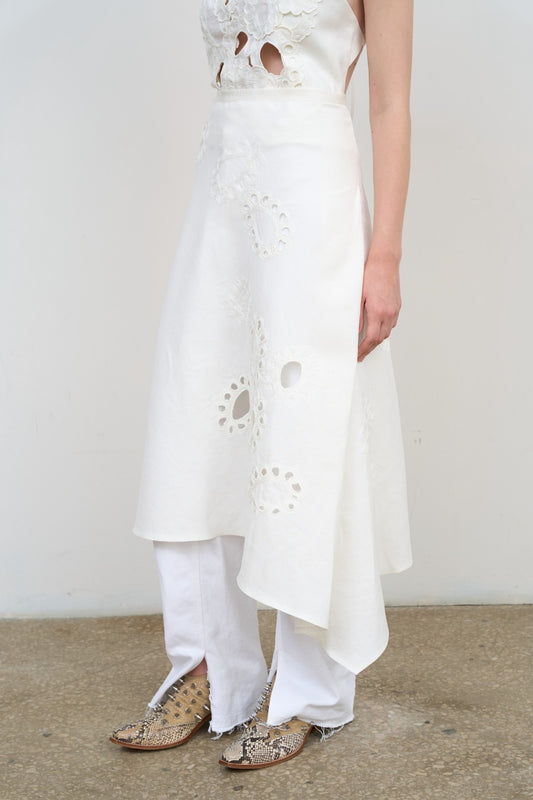 Model is wearing Litkovska white midi skirt with floral appliqué, crisp poplin, and balloon silhouette. A modern, sculptural, and artisanal piece that belongs to the curated selection of House of Nomad Stories.