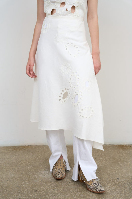 Model is wearing Litkovska white midi skirt with floral appliqué, crisp poplin, and balloon silhouette. A modern, sculptural, and artisanal piece that belongs to the curated selection of House of Nomad Stories.