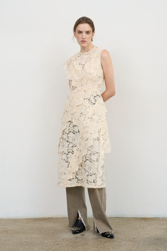 Model is wearing Litkovska ivory lace overlay midi dress with layered ruffles and high neck, a contemporary artisanal design that belongs to the curated selection of House of Nomad Stories.