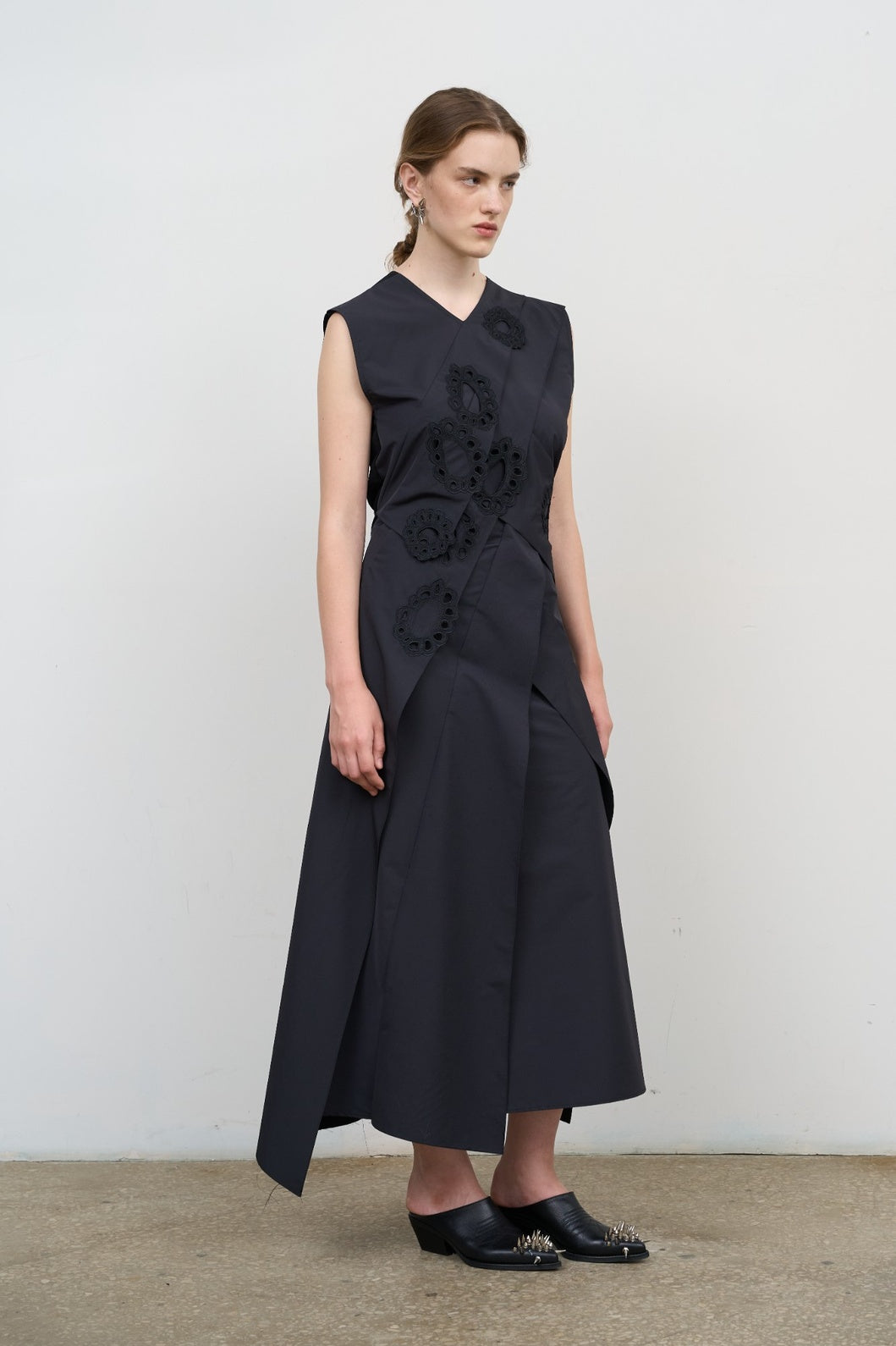 Model is wearing Litkovska layered black midi dress with deep V-neck, sleeveless cut, and floral embroidery. An elegant, modern, and artisanal piece that belongs to the curated selection of House of Nomad Stories.
